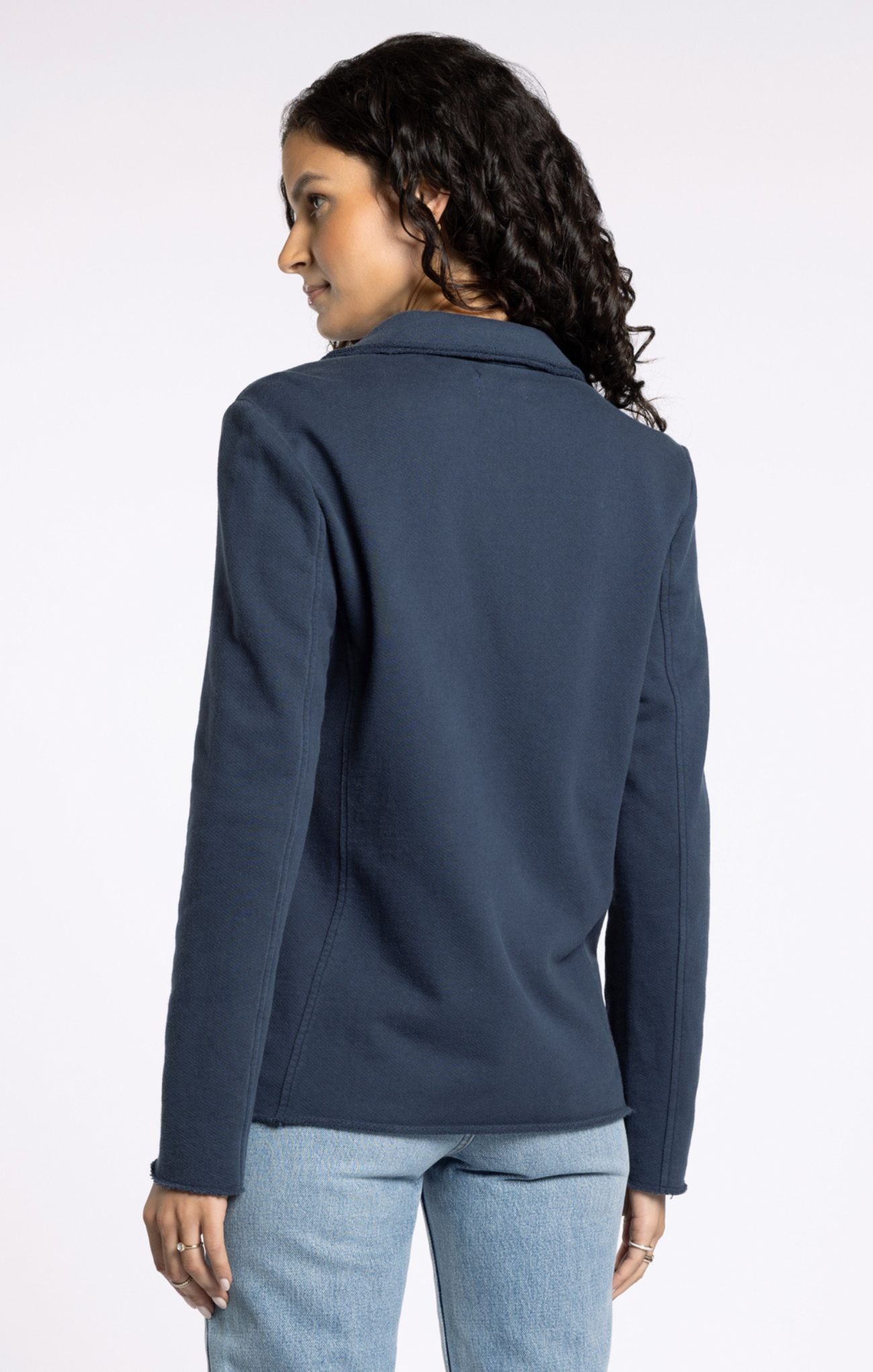 Woman wearing a dark blue jacket on a white background