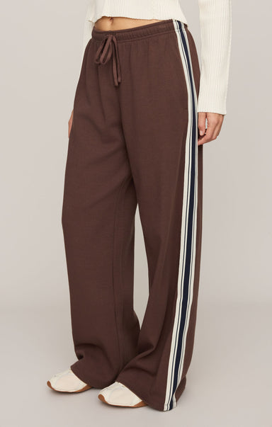 Brown pants with white stripes on a plain background