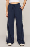 Navy wide-leg pants with white stripes on a plain background