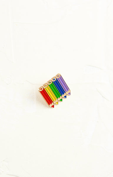 Colorful pencil-shaped pin on a white background