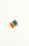 Colorful pencil-shaped pin on a white background