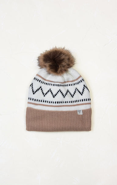 Knitted beanie with a patterned band and fur pom-pom on a white background