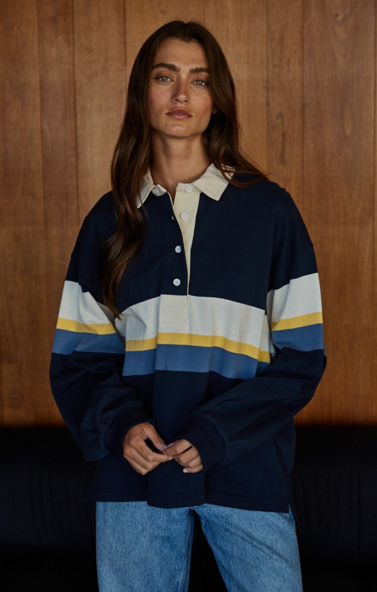 Woman wearing a striped shirt with a wooden background