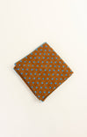 Brown fabric with blue polka dots on a beige background
