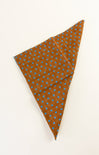 Brown fabric with blue polka dots folded on a white background