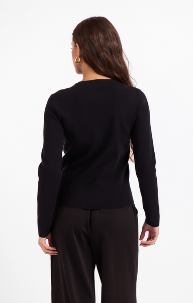 Person wearing a black long-sleeve top and black pants on a white background