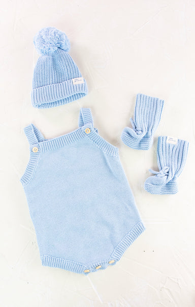 Blue knitted baby romper with matching hat and gloves on a white background