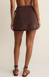 Brown skirt worn by a person on a beige background