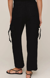Black pants worn by a person on a plain background