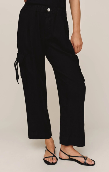 Person wearing black pants on a plain background