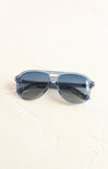 Blue sunglasses on a white surface