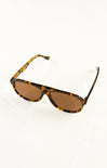 Sunglasses with tortoiseshell frame and brown lenses on a white background