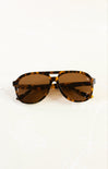 Tortoiseshell sunglasses with brown lenses on a white background