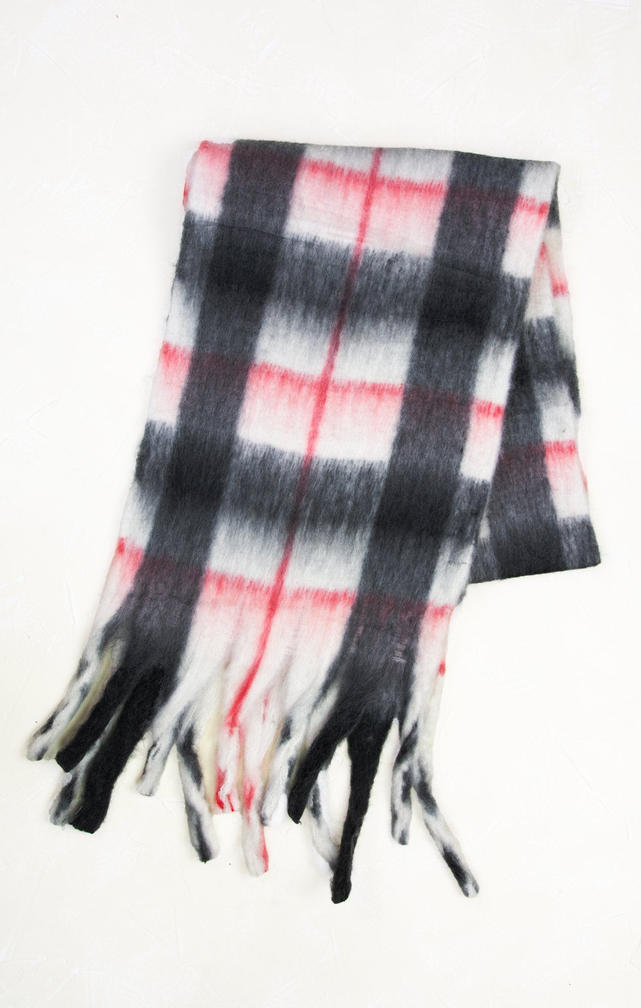Plaid scarf with fringe on a white background
