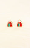 House-shaped earrings with red roofs and green bases on a beige background