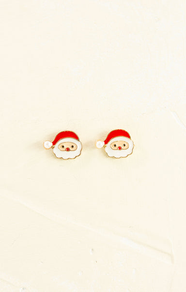 Santa Claus-themed earrings on a beige background