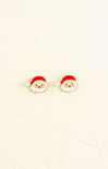 Santa Claus-themed earrings on a beige background