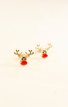 Gold reindeer-shaped earrings with red noses on a light beige background
