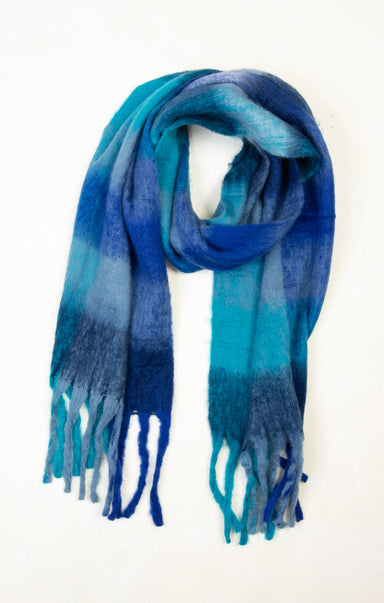Blue and green plaid scarf with fringes on a white background
