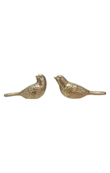 Two gold bird figurines on a white background