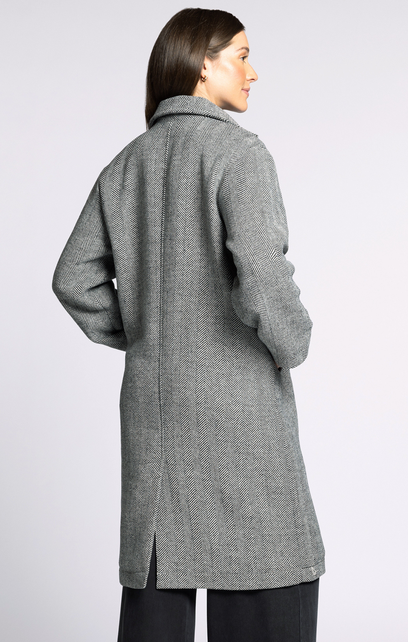 Woman wearing a gray coat on a white background