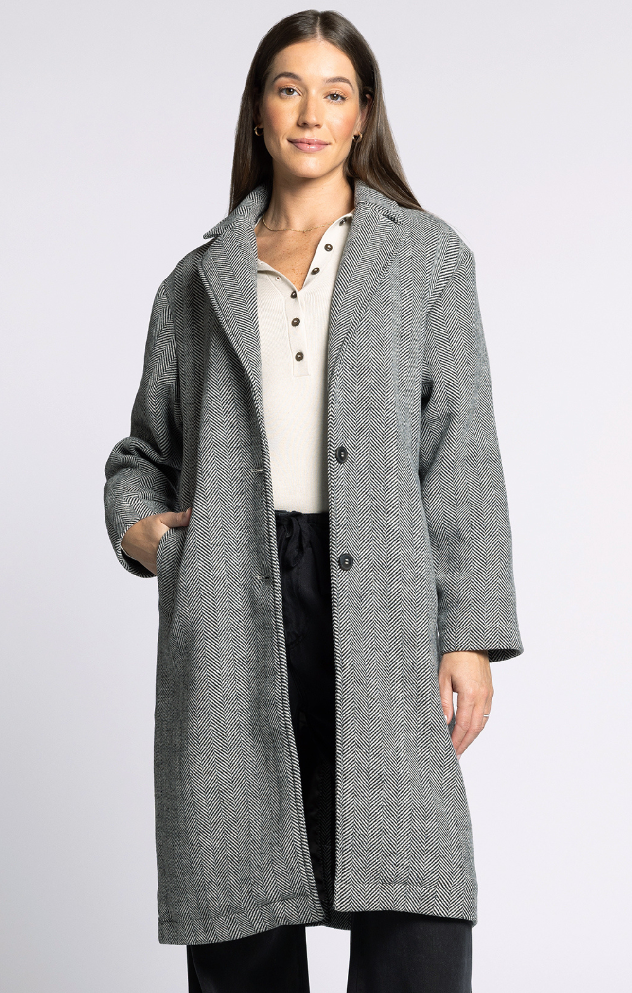 Woman wearing a gray coat on a white background