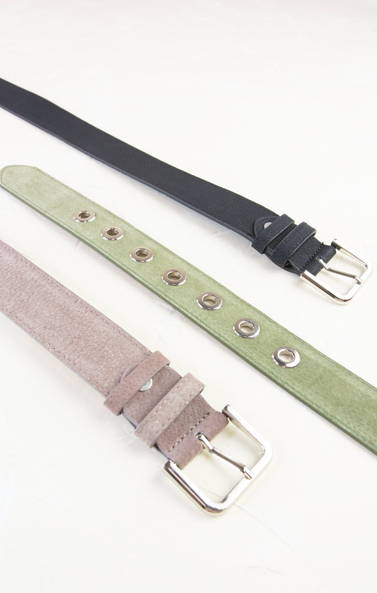 Three belts in black, green, and gray on a white background