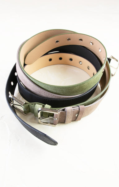 Set of leather belts in various colors on a white background