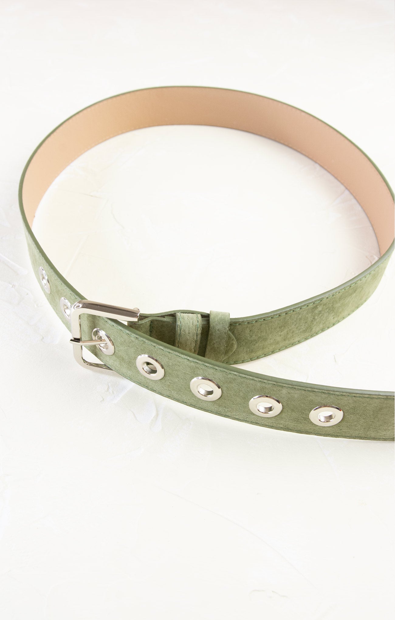 Green belt with silver studs on a white background