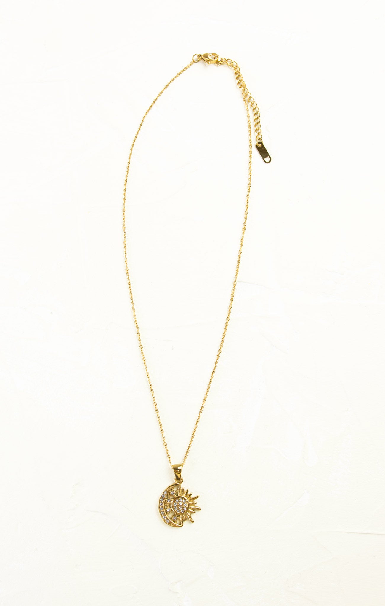 Gold necklace with a pendant on a white background