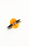 Butterfly-shaped hair clip with orange and clear design on a white background