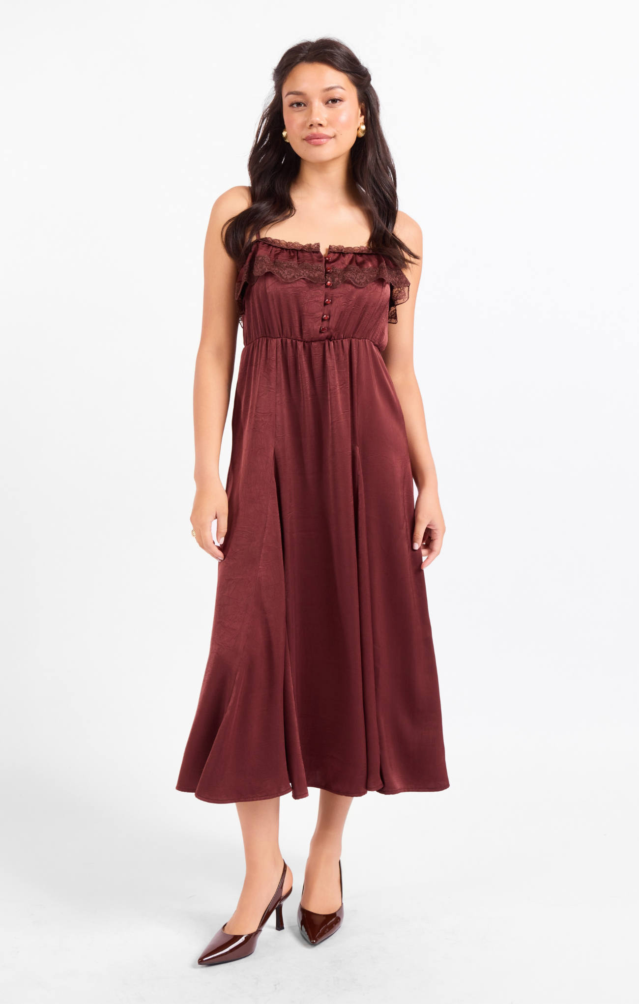 Woman wearing a burgundy dress on a white background
