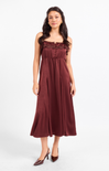 Woman wearing a burgundy dress on a white background