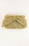 Gold beaded clutch with a bow on a white background