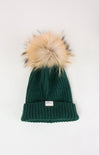 Green knit beanie with a faux fur pom-pom on a white background