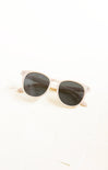 Sunglasses with gold frame and dark lenses on a white background