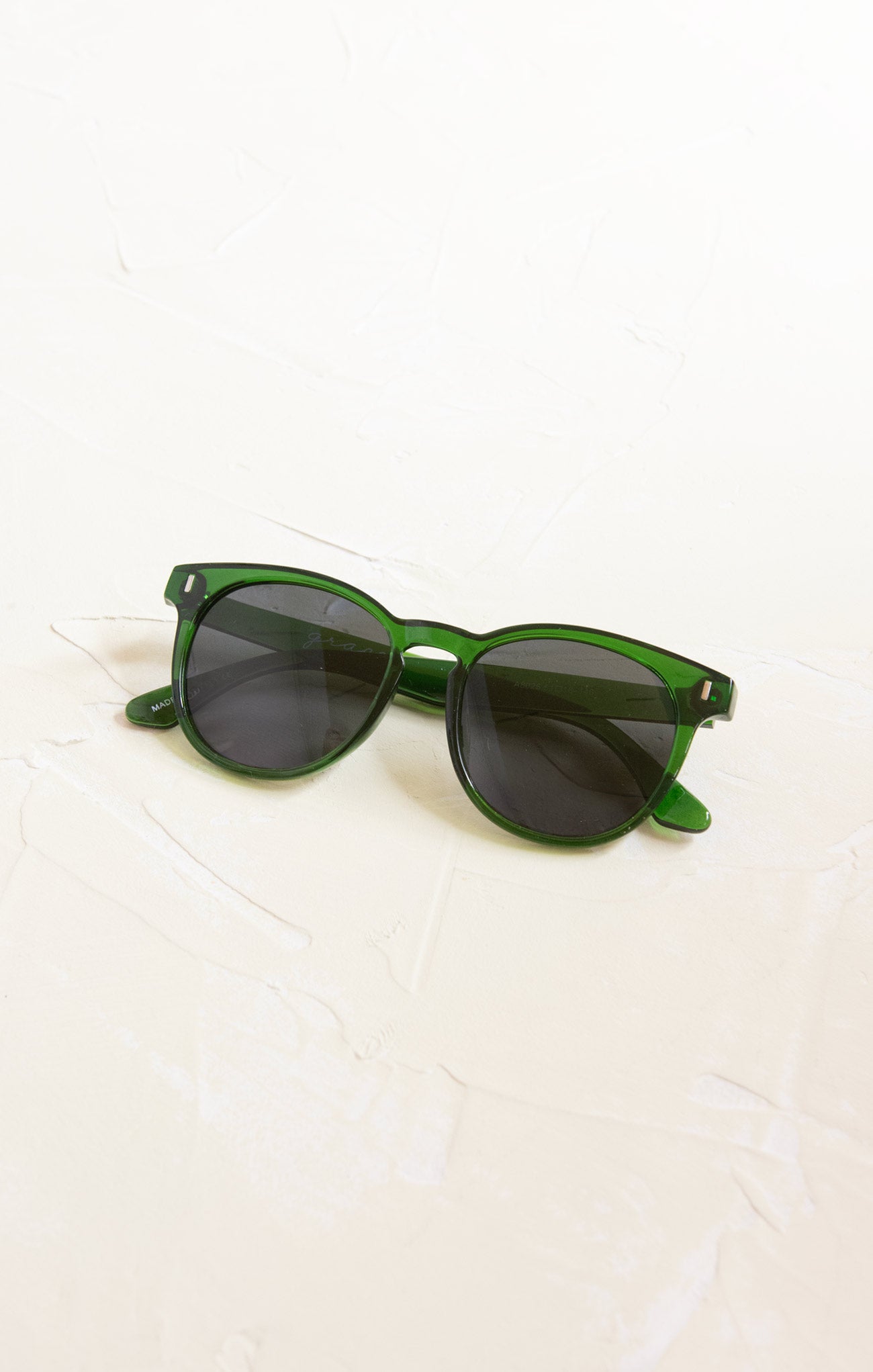 Green sunglasses on a white background