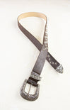 Brown leather belt with decorative buckle on a white background