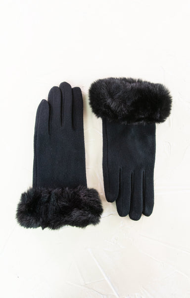 Pair of black gloves with fur cuffs on a white background