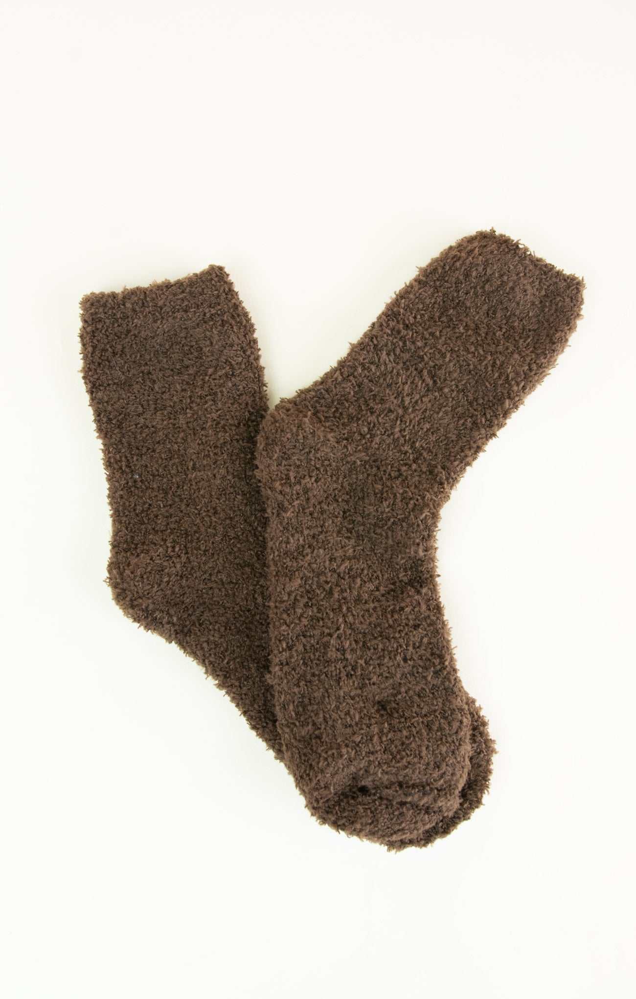 Pair of brown fuzzy socks on a white background