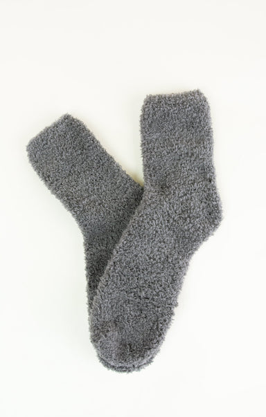Pair of gray fuzzy socks on a white background