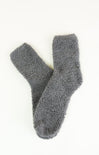 Pair of gray fuzzy socks on a white background