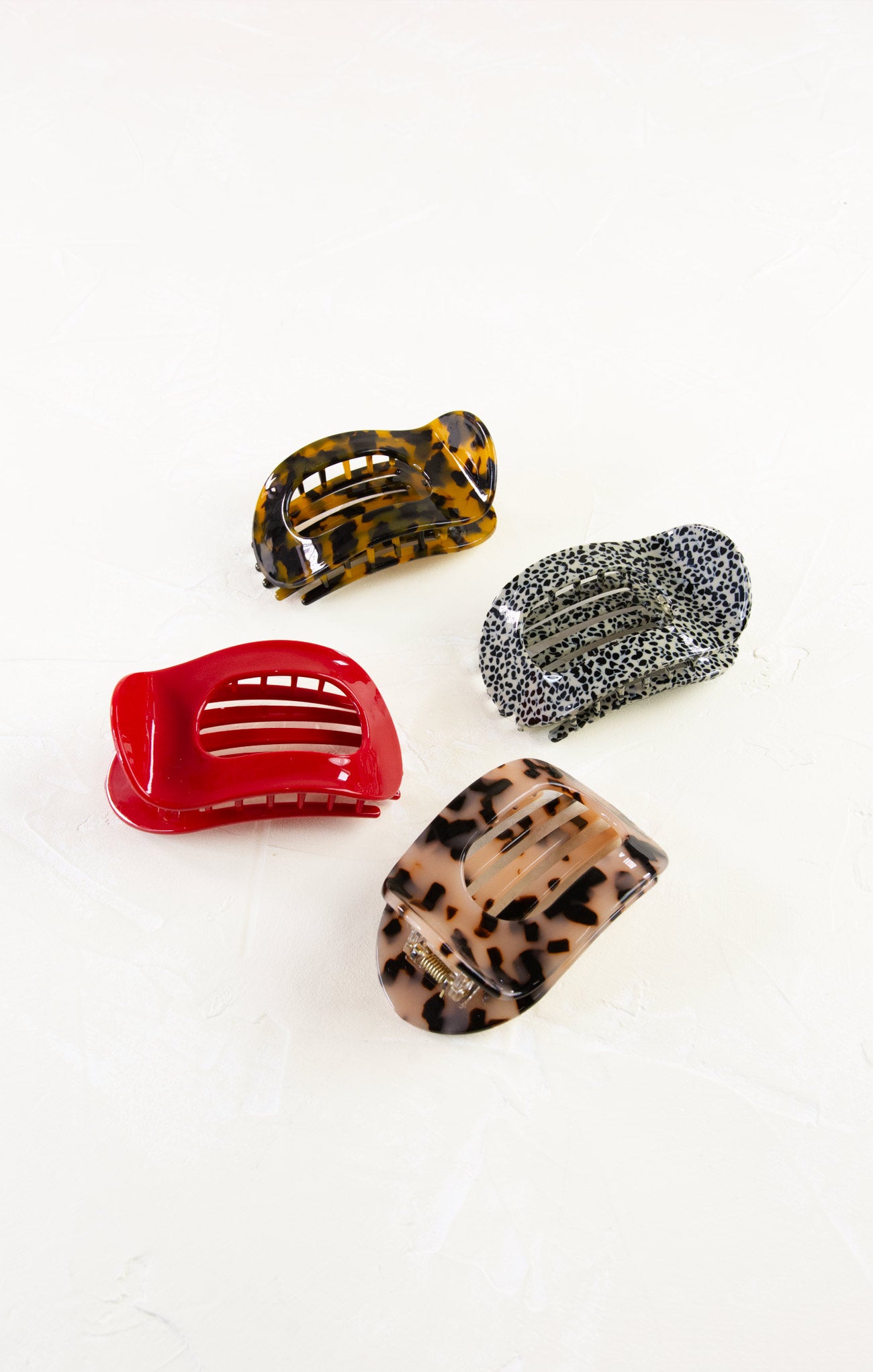Four colorful hair clips on a white background