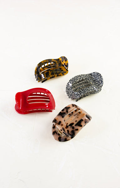 Four colorful hair clips on a white background