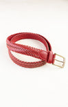 Red braided belt with a gold buckle on a white background