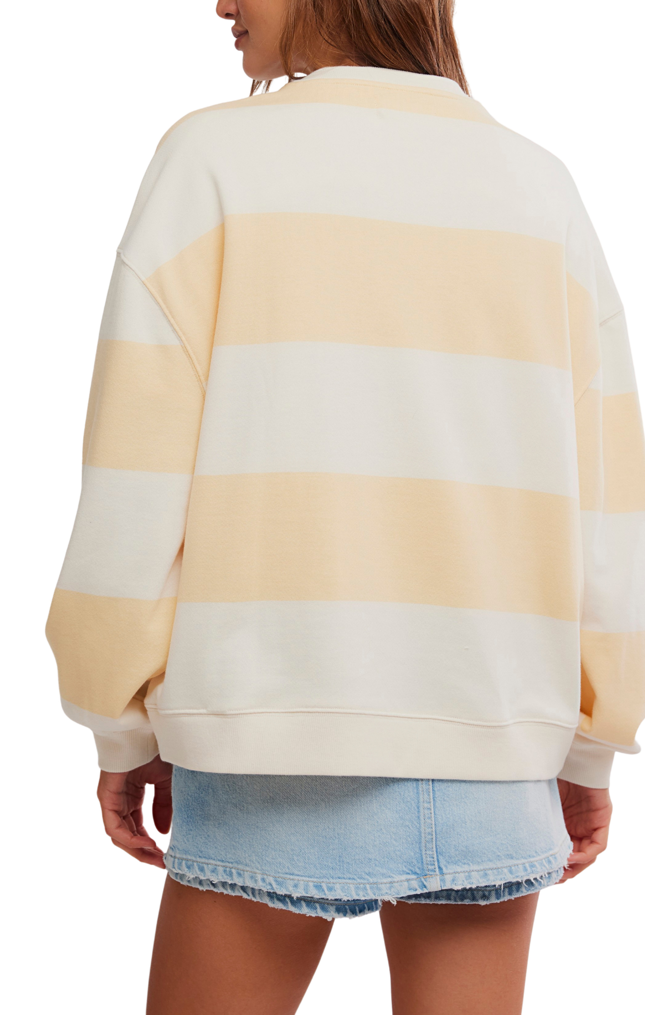 Person wearing a yellow and white striped sweater with denim shorts on a white background