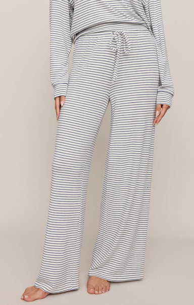 Person wearing a striped pajama set on a plain background