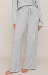Person wearing a striped pajama set on a plain background