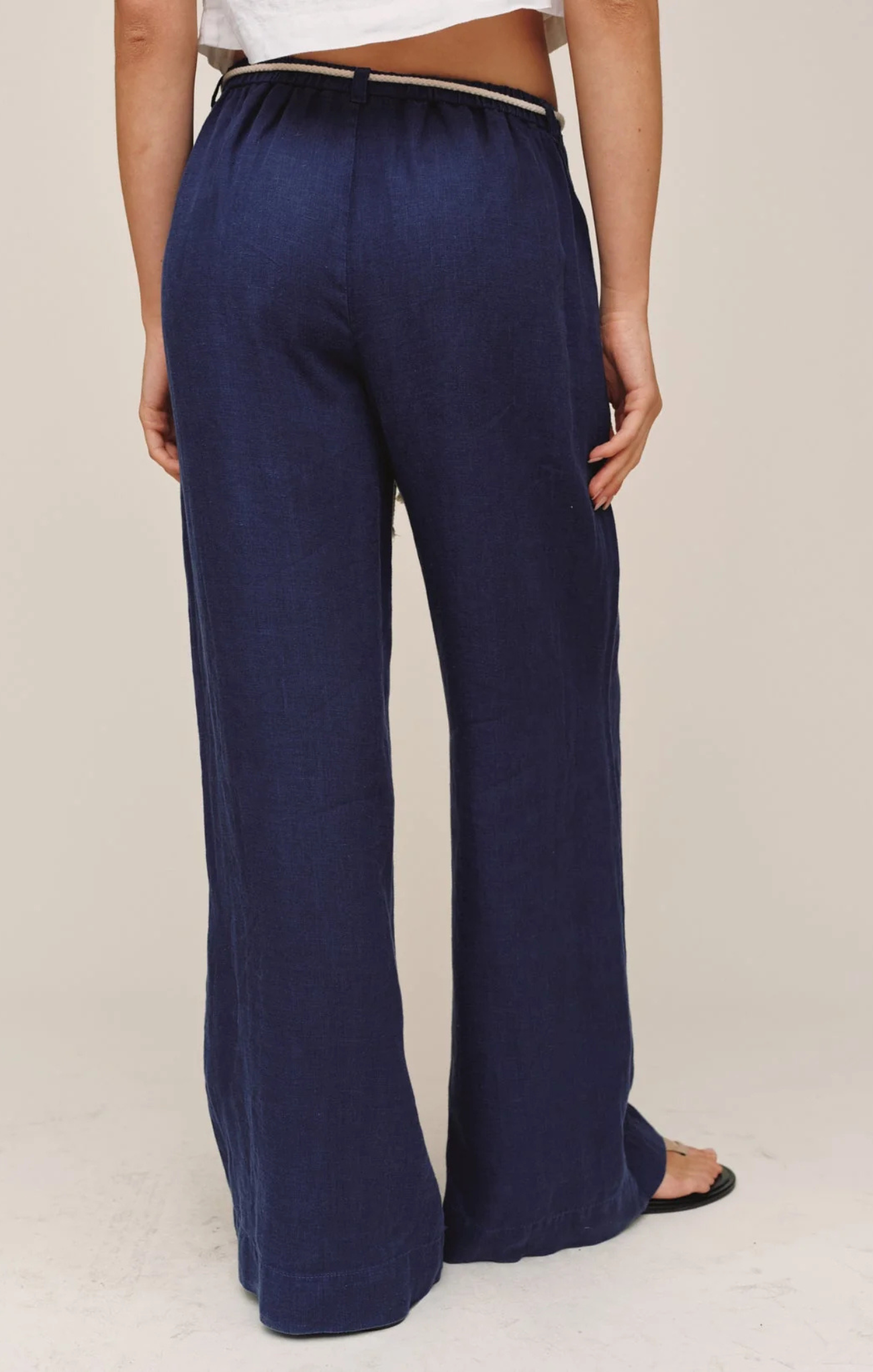 Navy blue wide-leg pants worn by a person on a plain background