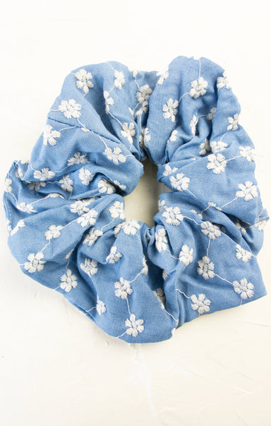 Blue floral scrunchie on a white background